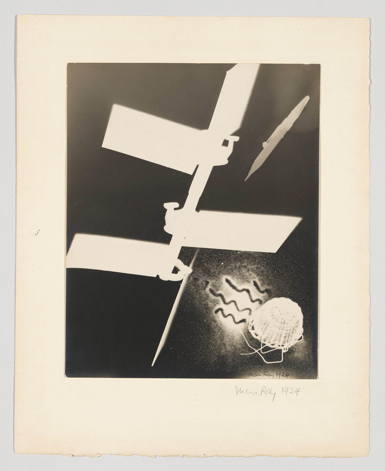 Abstract black and white composition with geometric shapes, a basket, and wavy lines; signed "Man Ray 1924."